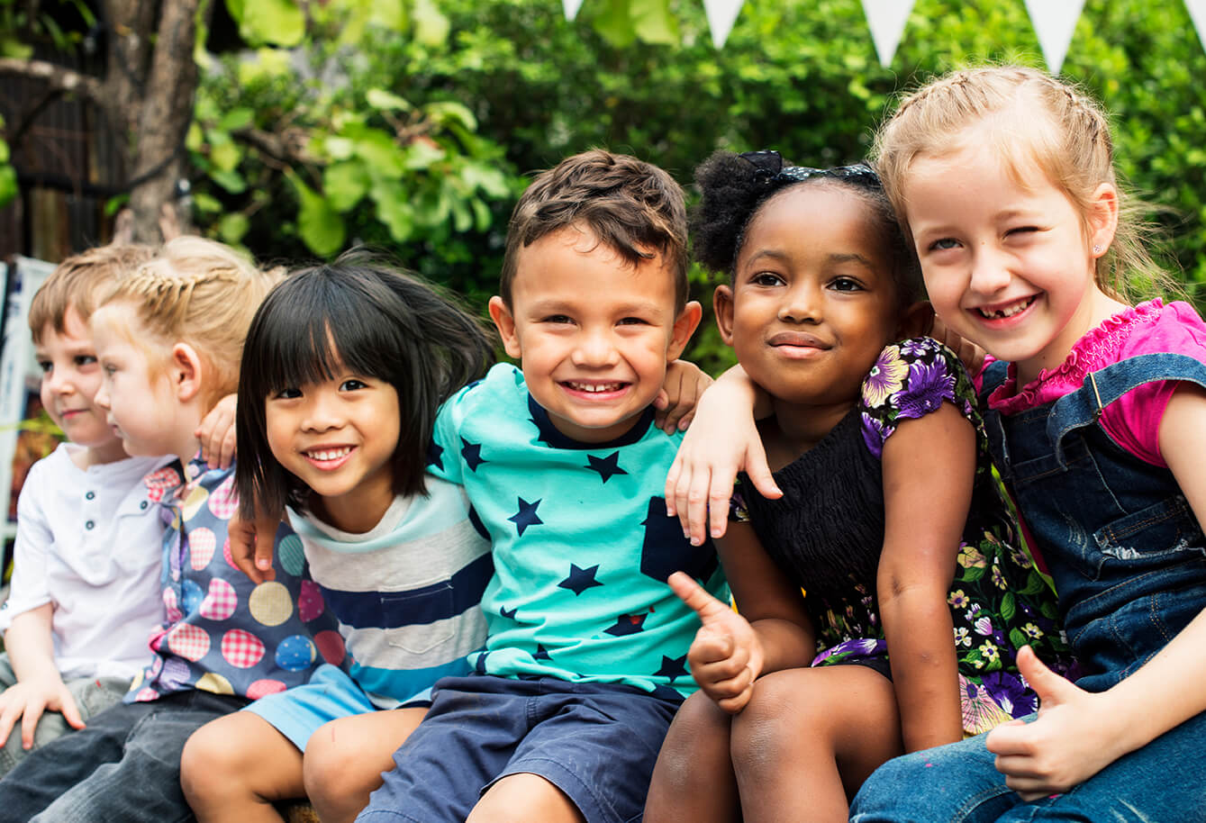 group of children sitting and smiling together