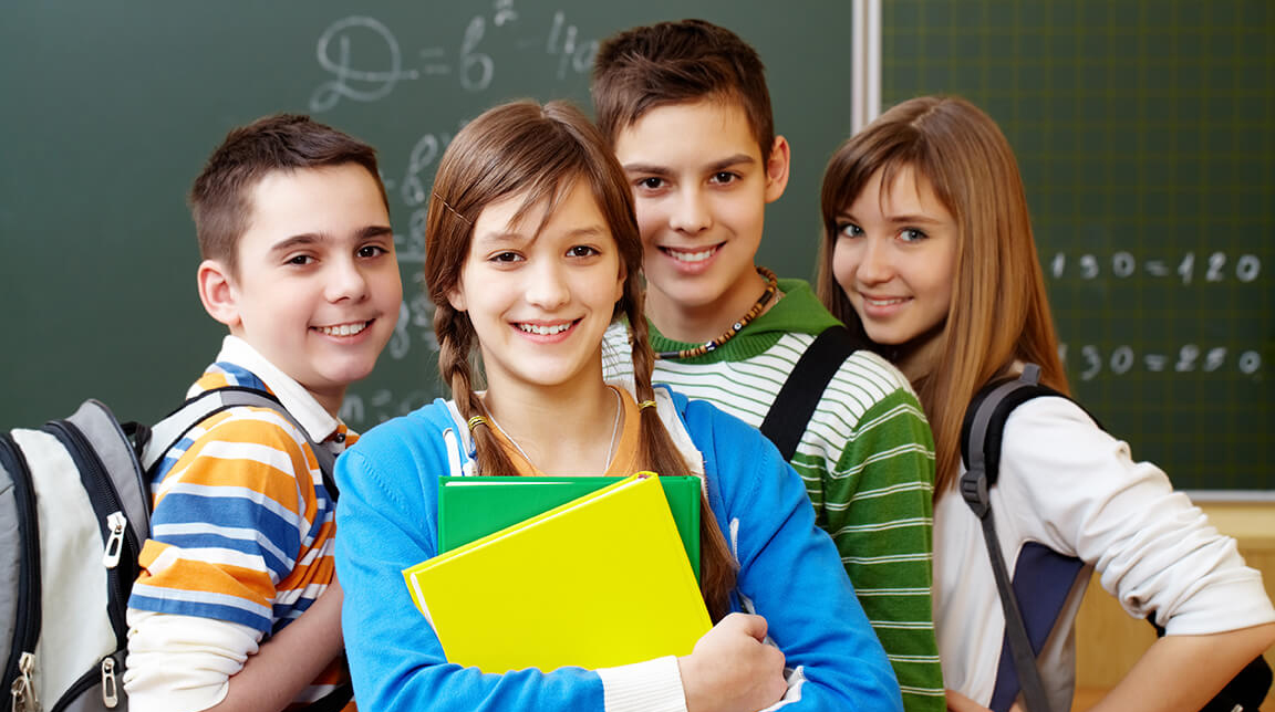 smiling students with backpacks